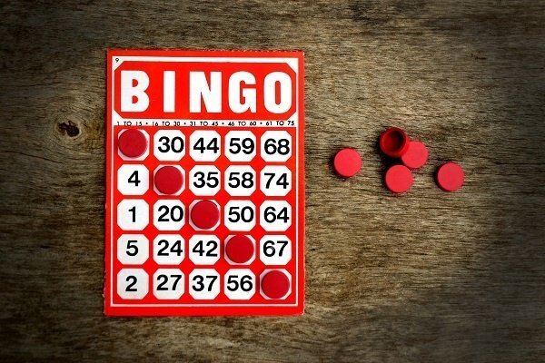 Red, white, and black bingo card with chips.