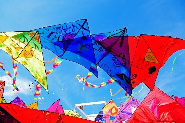 A group of colorful kites in the sky.