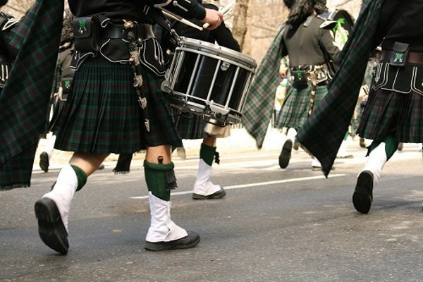 St. Patrick's Day parade with kilts and marching band.